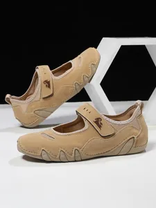 Women's tan suede Mary Jane sneakers with velcro strap and sporty sole design