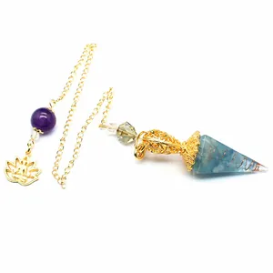 Detailed view of resin dowsing pendulum with blue crystals, gold chain and lotus charm