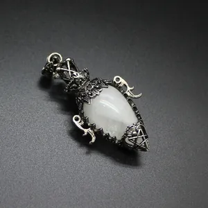Macro detail of a vintage silver teardrop crystal dowsing pendulum pendant stone