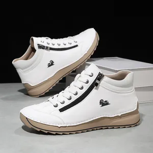 Detail shot of white casual sneakers featuring a side zipper and a small ram logo.