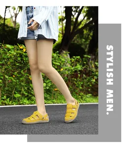 Close-up detail of stylish yellow hollow-out leather sandals for women in a park
