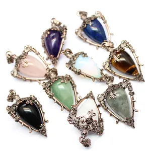 Detailed view showing medieval vintage style natural stone pendants with ornate bronze filigree