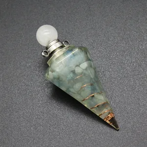 Detail view of a resin hexagonal cone pendant with tourmaline stones and copper coil