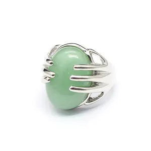 Close-up detail of a silver palm-shaped ring clutching a green oval natural stone