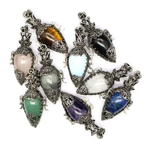 Group of antique silver filigree crystal dowsing pendulums in various natural stones