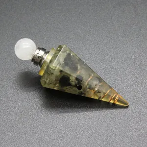 Close-up detail of natural tourmaline gravel inside a resin hexagonal cone bottle pendant