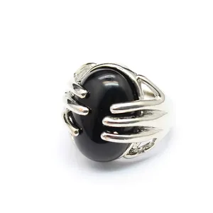 Close-up of unique vintage silver palm design ring with a large oval black natural stone