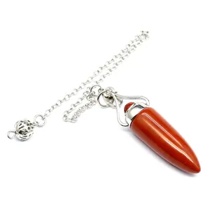 Detailed macro view of a natural red jasper bullet-shaped pendulum with a silver chain