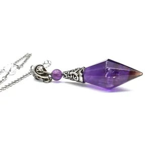 Detailed view of a double-pointed amethyst crystal pendulum with ornate silver metal cap.