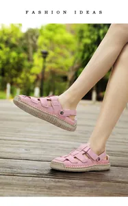 Casual pink leather sandals for women with rubber sole shown outdoors on a wooden deck