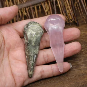 Detailed view of hand-carved rose quartz and pyrite bird skull ornaments