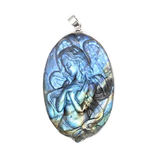Detailed view of carved labradorite pendant featuring a winged angel figure.