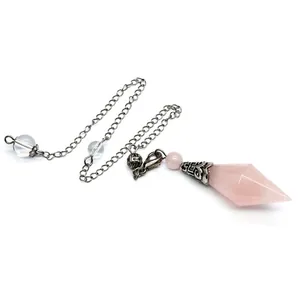 Macro detail of natural rose quartz faceted dowsing pendulum with vintage silver chain