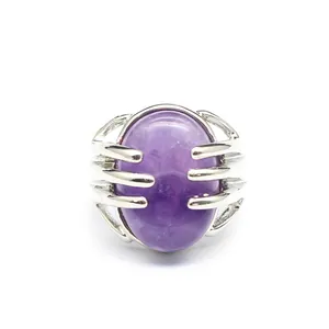 Detail of silver claw ring holding a large oval purple amethyst crystal stone