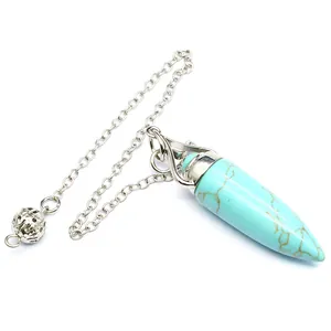 Detailed close-up of a natural turquoise bullet pendulum pendant on a silver chain.