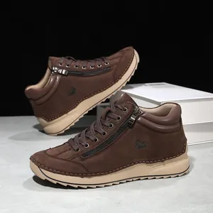 Detailed side view of brown handmade stitched casual high-top shoes with side zipper