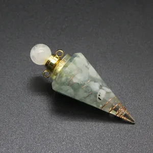 Macro detail of hexagonal resin cone pendant filled with natural tourmaline stone chips