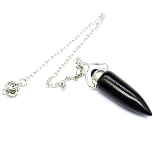 Detail of a black natural stone bullet-shaped dowsing pendulum with silver chain.