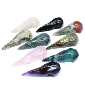 Collection of hand-carved natural crystal bird skull ornaments in assorted gemstones