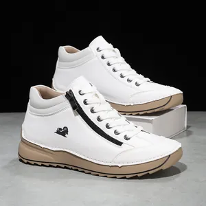 Close-up of white casual high-top shoes with side zipper and handmade stitching