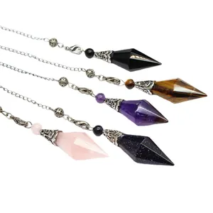 Set of five unique hexagonal crystal dowsing pendulums with ornate silver chains.