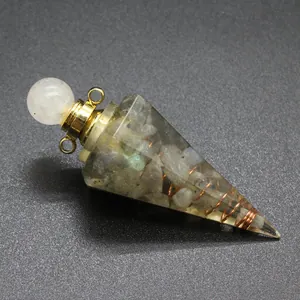 Detailed view of resin pyramid craft with natural tourmaline stones and copper wire