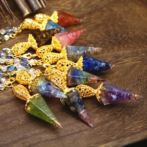 Macro view of various natural crystal resin hexagonal cone pendulums on a wooden tray.