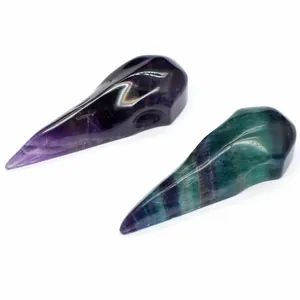 Close-up of bird skull carvings made from natural fluorite and amethyst crystal.