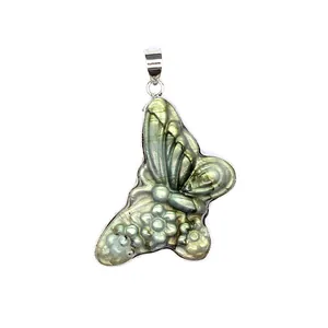 Detailed close-up of a hand-carved butterfly labradorite stone pendant with floral motifs