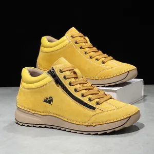 Detail of yellow suede casual shoes with side zipper and hand-stitched seams.