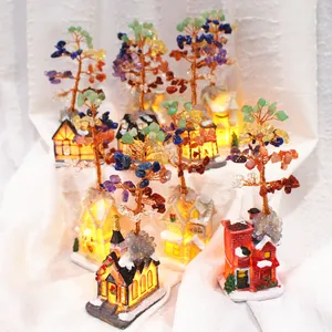 Detailed view of handmade multi-colored chakra crystal trees with warm glowing house bases