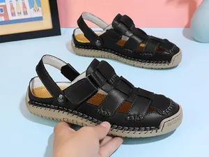 Detailed side view of black leather caged sandals featuring a thick beige sole and stitching.