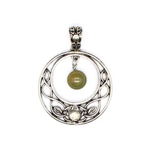 Close-up of vintage silver Celtic moon pendant featuring a green natural stone bead.
