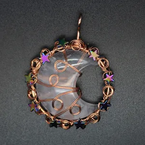 Detailed view of handmade copper wire-wrapped crescent moon pendant with iridescent stars