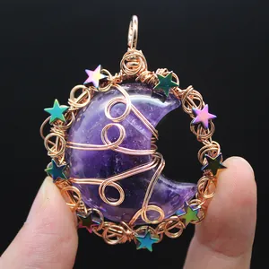 Intricate wire-wrapped detail on a crescent moon pendant with iridescent stars