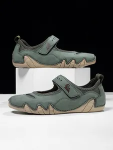 Side view detail of green Mary Jane casual sneakers with hook and loop closure and wavy sole.