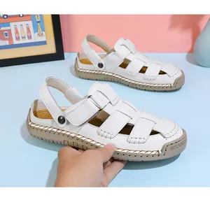Detailed view of white handmade stitched leather sandals featuring flexible rubber sole