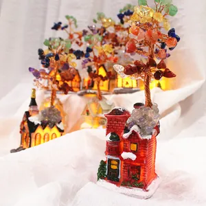 Detailed view of hand-woven chakra crystal tree on a glowing miniature house base