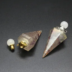 Detail of hexagonal resin perfume bottle with tourmaline stones and copper wire wrapping.