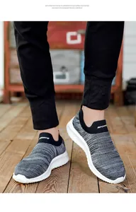 Detailed macro shot of grey breathable knit running shoes with lightweight white EVA soles