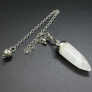 Detail view of a white bullet-shaped crystal pendulum pendant on a silver chain