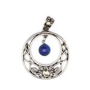 Detailed view of vintage silver hollow moon pendant with blue lapis stone.