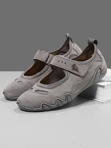 Close-up view of grey Mary Jane sneakers featuring breathable mesh and a sturdy Velcro strap.