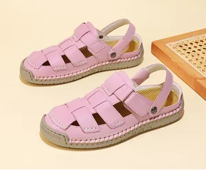 Close-up of pink hand-stitched fisherman sandals with a thick rubber sole for women.