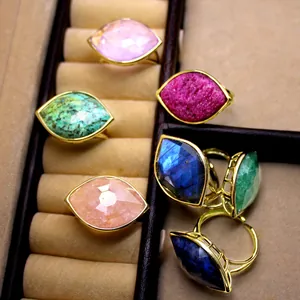 Close-up detail of faceted marquise crystal rings displayed in a beige jewelry box