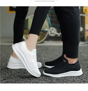 Macro view of black and white breathable lightweight slip-on running shoes for couples