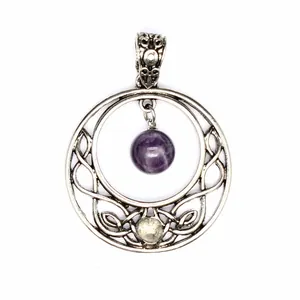 Close-up of a vintage silver-tone pendant with a dangling purple amethyst bead detail.
