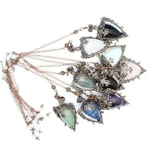 Close-up detail of medieval vintage natural stone pendulum necklaces in diverse colors