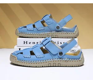 Side profile of light blue leather women sandals with white stitching and tan soles.