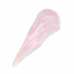 Detailed view of a hand-carved rose quartz bird skull ornament for Halloween decor.